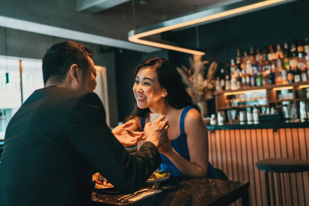 Beautiful asian woman's happy surprised by engagement proposal stock photo