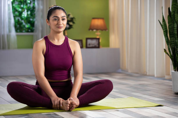 bella giovane donna attraente che fa yoga esercitandosi a casa, concetto di salute, concetto di fitness, foto d'archivio - baddha konasana foto e immagini stock
