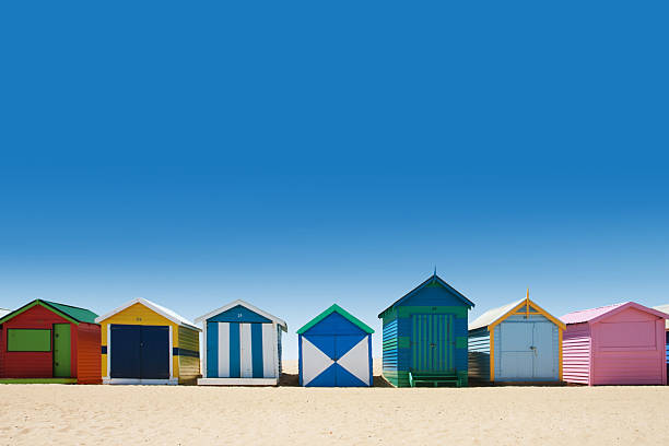 Beautiful bathing houses on white sand beach stock photo