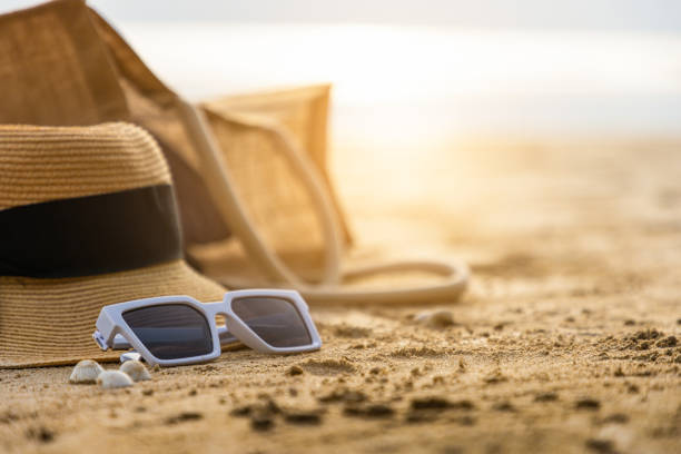 Beautiful beach with sunglasses and hat on the beach. stock photo