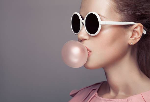 Beautiful blonde woman. Fashion portrait. Blowing bubble gum. stock photo