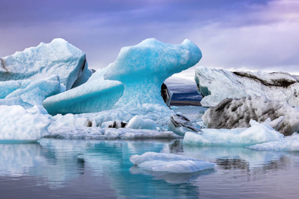 Beautiful blue icebergs reflected in the Jokulsarlon glacial lagoon, Southern Iceland. stock photo