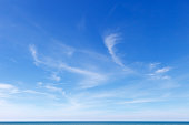 istock Beautiful blue sky over the sea with translucent, white, Cirrus clouds 1301058723