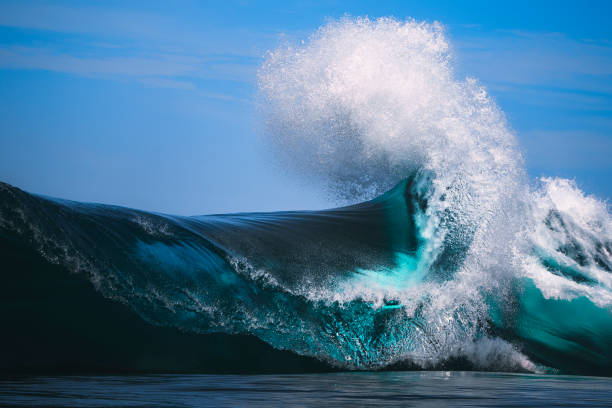 Beautiful blue wave curling out at sea stock photo