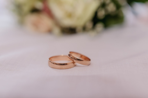 Beautiful bouquet, pair of gold wedding rings