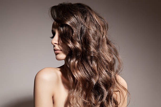 Beautiful Brunette Woman. Curly Long Hair. stock photo