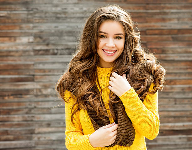 Beautiful  brunette woman over wooden background. stock photo