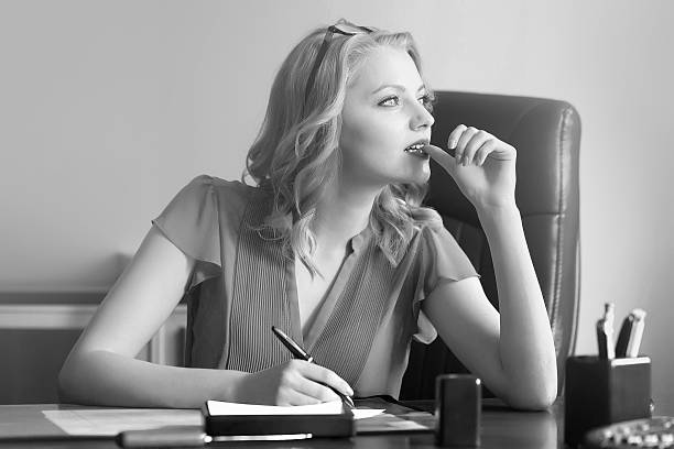Beautiful young elegant smart business woman sitting in office on...