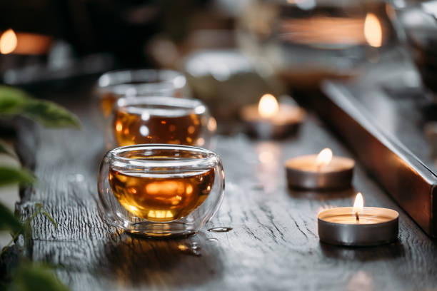 Beautiful chinese tea in teacup with candle flame decoration stock photo