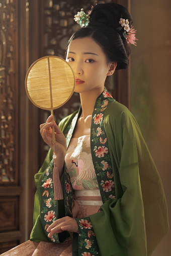 Beautiful Chinese woman in period costume hanfu photographed in a studio portrait setting