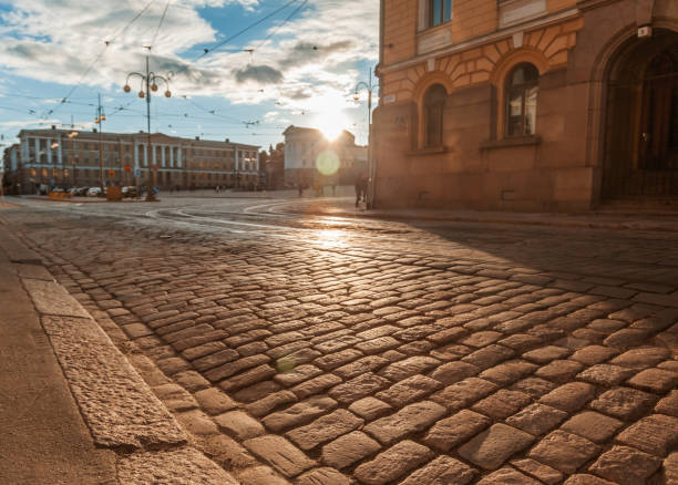 Beautiful cityscape, Helsinki, street in the historical center of the city with paving stones in the rays of the setting sun stock photo
