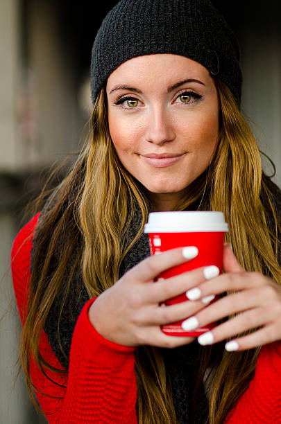 Beautiful coffee drinker with green eyes stock photo