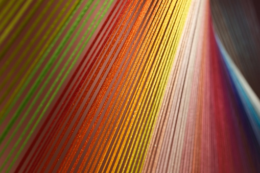 close up colorful cotton threads under light. Beautiful string background