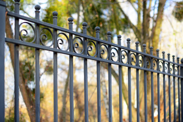 Beautiful decorative cast metal wrought fence with artistic forging. Iron guardrail close up. stock photo
