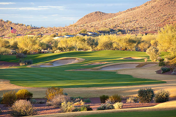 Beautiful Desert Golf Course A beautiful desert golf hole. Mesa, Arizona, United States. Golf in the Valley of the Sun is a massive industry, with over 200 golf courses. This is one of the golf hot spots in North America and the world. Nobody is in this scenic image of a golf hole in the desert. Beautiful turf conditions and manicured golf greens.  mesa stock pictures, royalty-free photos & images