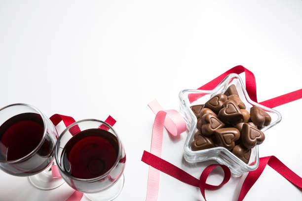 Beautiful display of love with chocolate and wine on white background stock photo