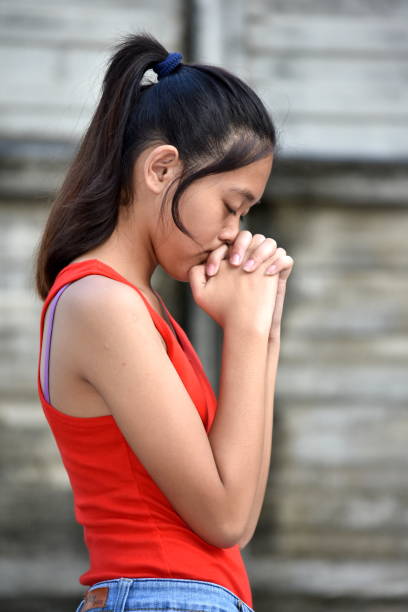 A Beautiful Diverse Girl Teenager Praying A person in an outdoor setting philippines girl stock pictures, royalty-free photos & images