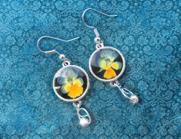 Beautiful earrings with flowers in resin. Women's jewelry, Beautiful earrings with flowers in resin. Women's jewelry, accessory. fossilized pitch stock pictures, royalty-free photos & images