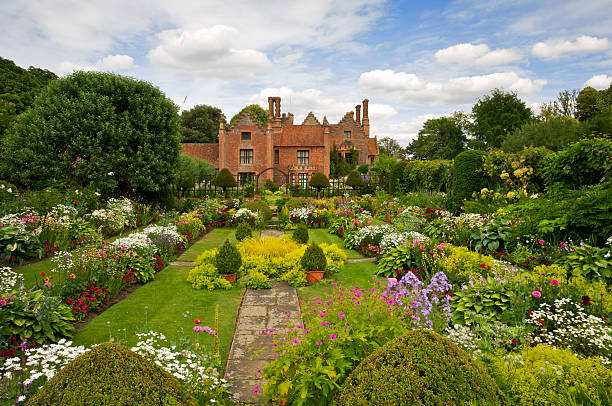 Beautiful English Garden The beautiful award winning gardens of Chenies Manor in Buckinghamshire with a wide variety of flowering plants and shrubs. garden path stock pictures, royalty-free photos & images