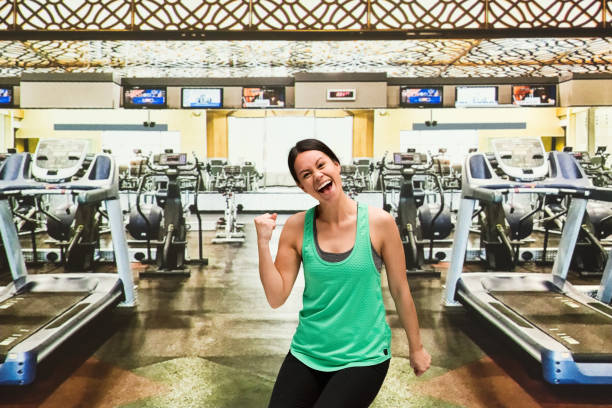 Beautiful female at the gym doing a fist pump stock photo