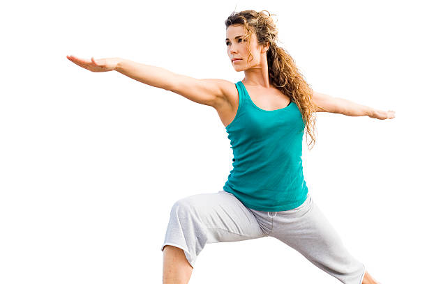 Beautiful female doing yoga warrior pose stock photo