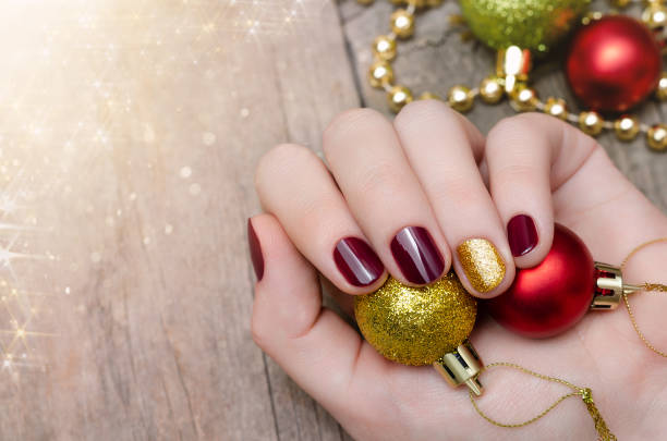 Beautiful female hand with Christmas nail design stock photo