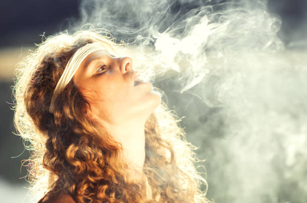 Beautiful free hippie girl blowing smoke - Vintage effect photo Beautiful free hippie girl blowing smoke. High, stoned, relax - Vintage effect photo little girl smoking cigarette stock pictures, royalty-free photos & images