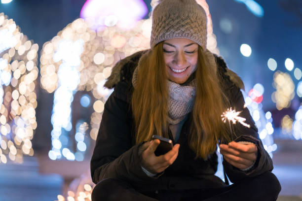 Beautiful girl texting during holidays stock photo