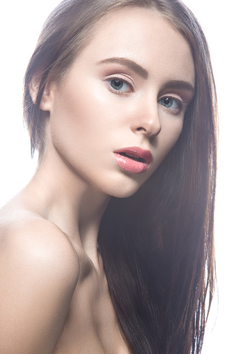 Portrait of a young naked woman posing in beautiful makeup 