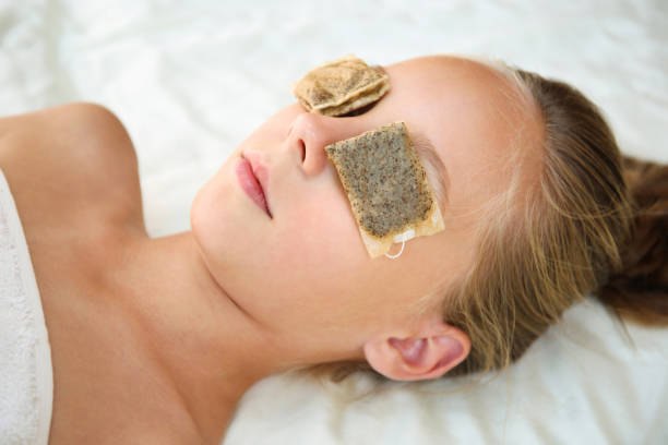 Beautiful girl with tea bags on eyes. Top view.  tea bags stock pictures, royalty-free photos & images