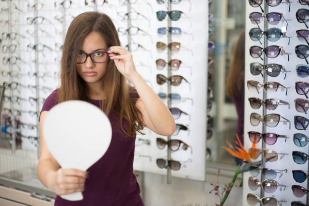 Beautiful girls choosing glasses stock photo
