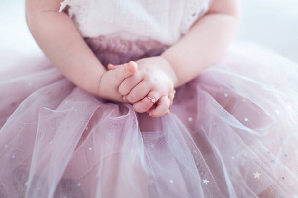 beautiful golden finger ring on the little hands of adorable toddler princess girl beautiful golden finger ring on the little hands of adorable toddler princess girl gold ring on finger stock pictures, royalty-free photos & images