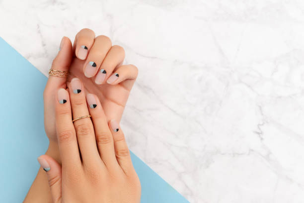 Beautiful groomed womans hands with nude and blue matte nail design Beautiful groomed womans hands with nude and blue matte nail design. Manicure pedicure beauty salon concept. nail art design stock pictures, royalty-free photos & images