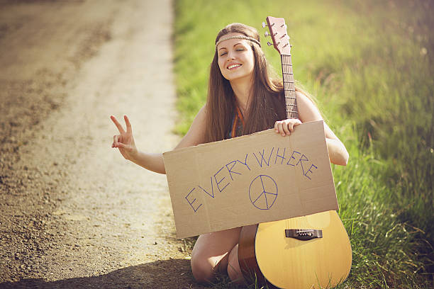 Beautiful hippie woman on a country road stock photo