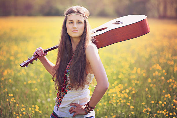 Beautiful hippie woman with guitar stock photo