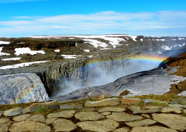 Beautiful icelandic rainbow over famous waterfall Dettifoss in Iceland. Picturesque vivid landscape. Stunning view on waterfall and snowy mountains. Summer in Iceland. Natural icelandic beauty Iceland, Golden circle. dettifoss waterfall stock pictures, royalty-free photos & images
