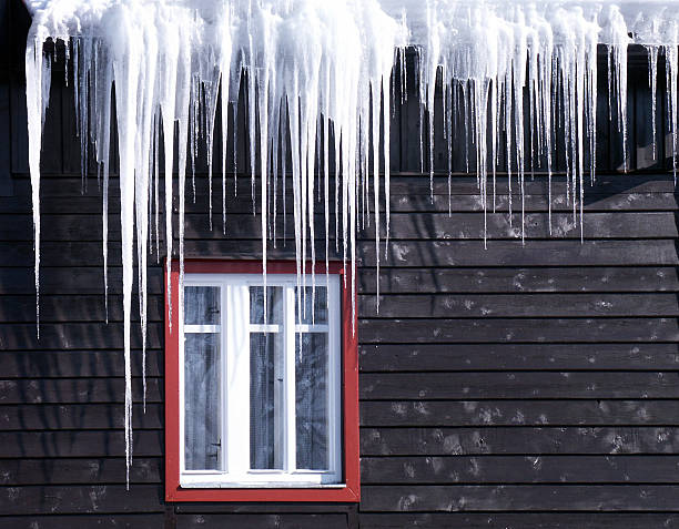 Beautiful icicles cascading from a roof and providing a view stock photo