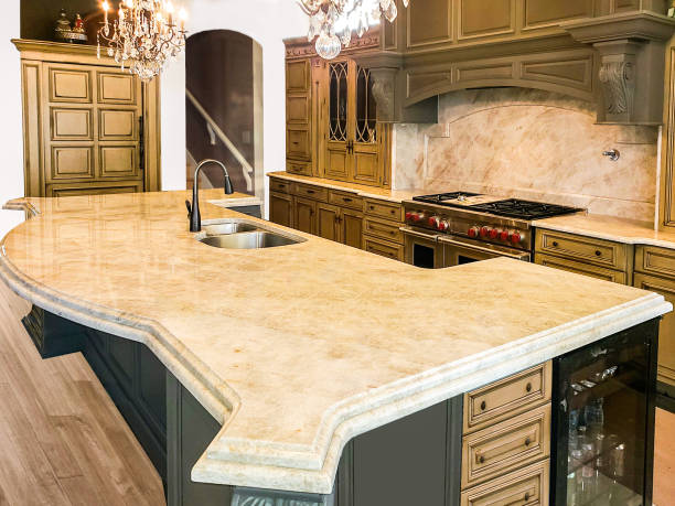 Beautiful Kitchen in Luxury Home with large island, pendant lights, range, and hood. Beautiful Kitchen in Luxury Home with large island, pendant lights, range, and hood. Cabinets and Island are made of wood limestone stock pictures, royalty-free photos & images