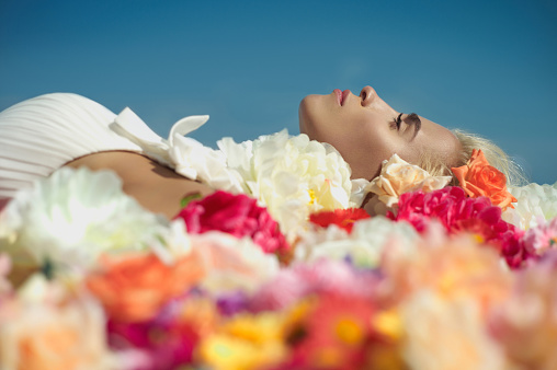 Woman Lying On Bed Of Flowers · Free Stock Photo