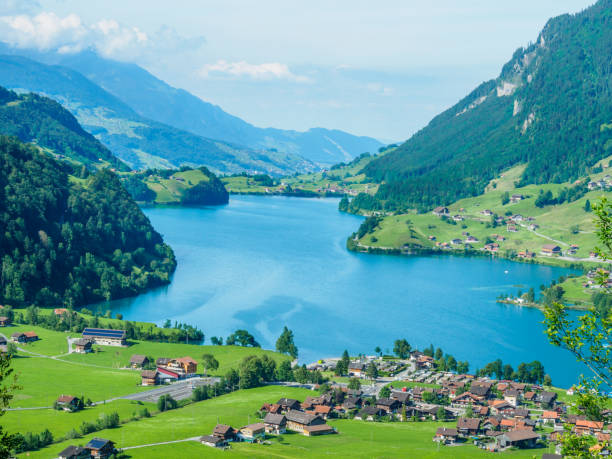 Beautiful lake Lungern and village from Brunig Pass, Switzerland. High view point lake Lungern and village from Brunig Pass, Switzerland. lungern village switzerland lake stock pictures, royalty-free photos & images
