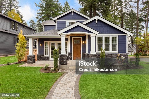 istock Beautiful Luxury Home Exterior with Green Grass and Landscaped yard 856794670