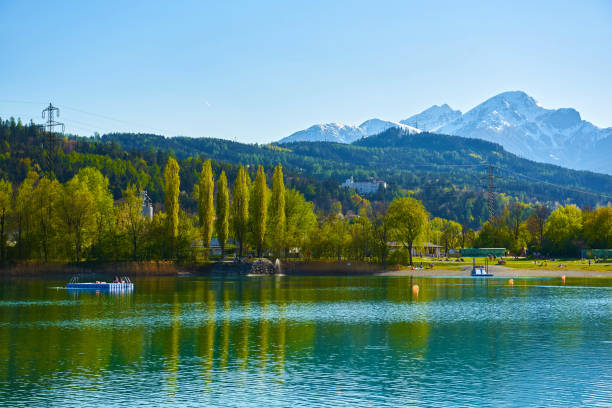 beautiful mountains and a lake in autumn.  baggersee (badesee rossau), innsbruck, austria. - badesee stock-fotos und bilder