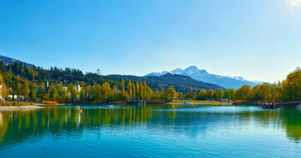 beautiful mountains and a lake in autumn.  baggersee (badesee rossau), innsbruck, austria. - badesee stock-fotos und bilder