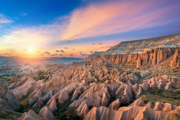 Beautiful mountains and Red valley  at sunset in Goreme, Cappadocia in Turkey. stock photo