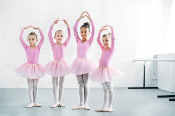 Beautiful Multiethnic Kids In Pink Tutu Skirts Practicing Ballet Together