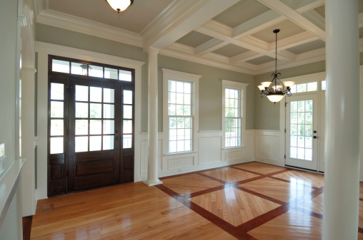Beautiful new foyer with intricate hardwood floor pattern.