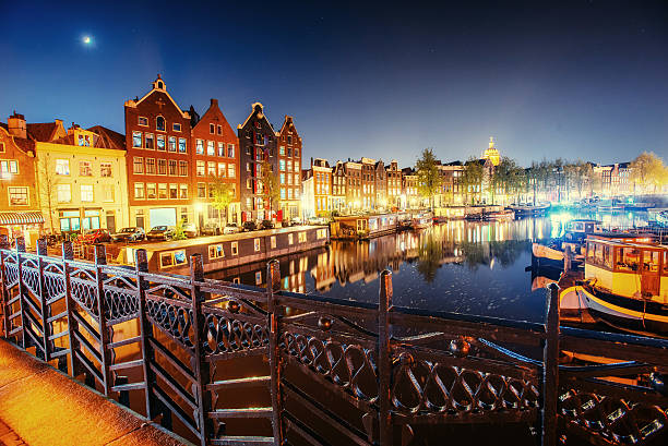 Beautiful night in Amsterdam. Night illumination of buildings and...