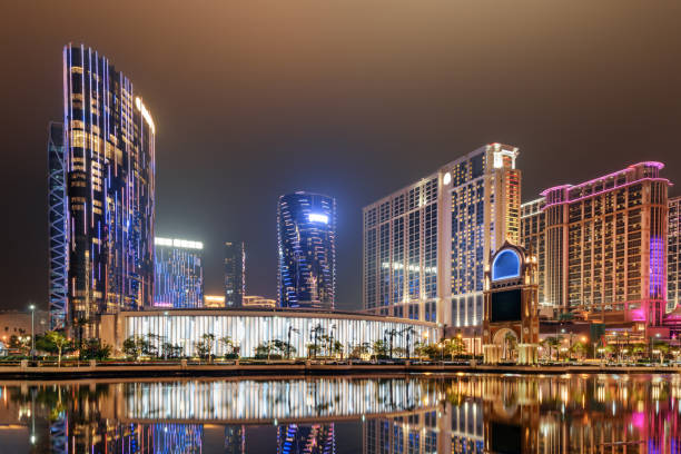 Beautiful night view of modern buildings in Cotai of Macau Beautiful night view of modern buildings in Cotai of Macau. Colorful city lights reflected in water. Wonderful cityscape. Cotai is a new gambling and tourism area with casinos and shopping malls. cotai strip stock pictures, royalty-free photos & images