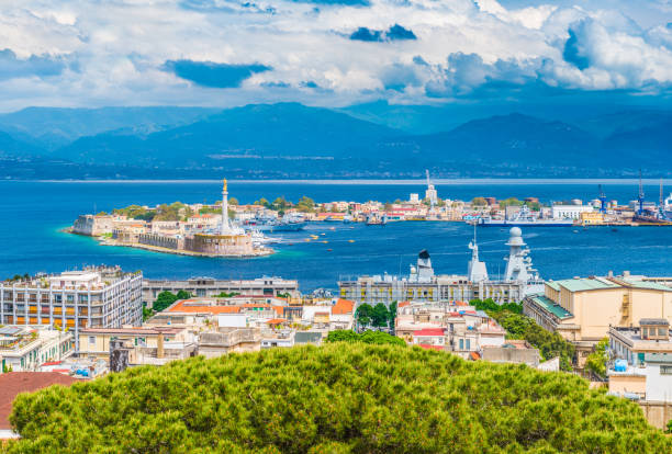 Beautiful panorama of Messina port with blue mountains in the background. It is written on the seawall in Latin "Vos Et Ipsam Civitatem Benedicimus (I Bless You And Your City), Sicily, Italy stock photo