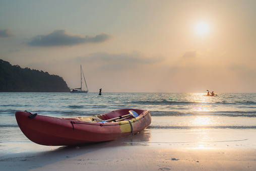 Beautiful panoramic view of sand beach and colourful kayak in summer vacation ,Active rest, sport, kayak. Boat for rafting on water. A few kayaks stand on a sandy beach..